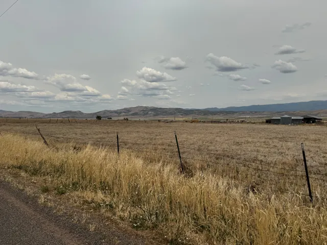 Expansive open fields with distant mountain scenery