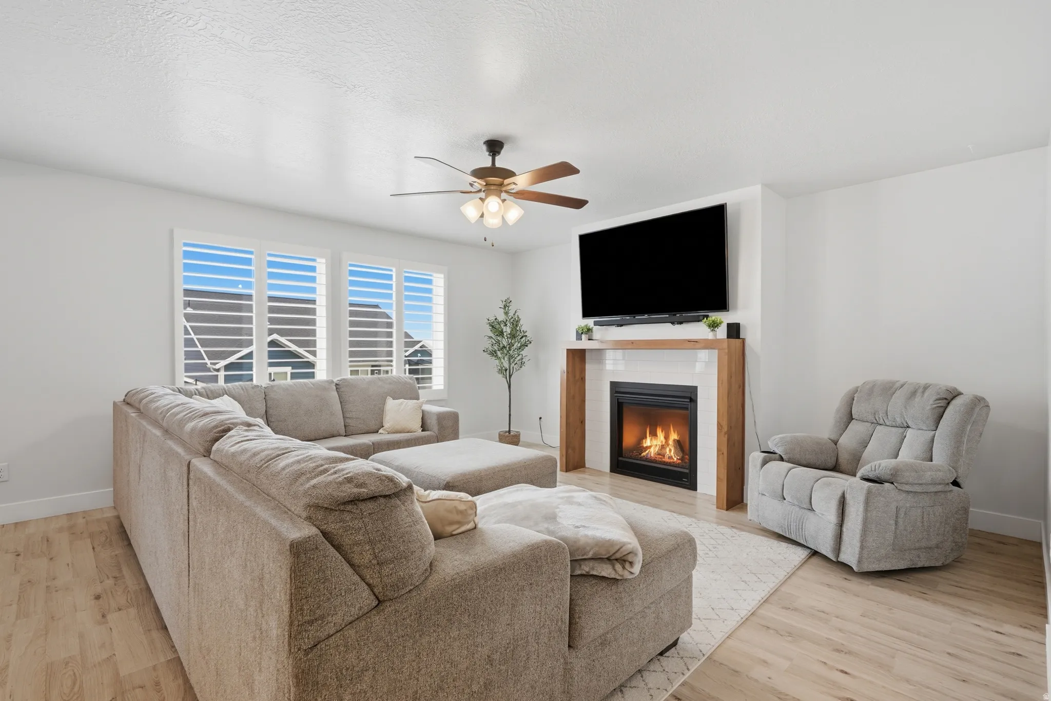 Living area featuring light wood-finish flooring and white walls