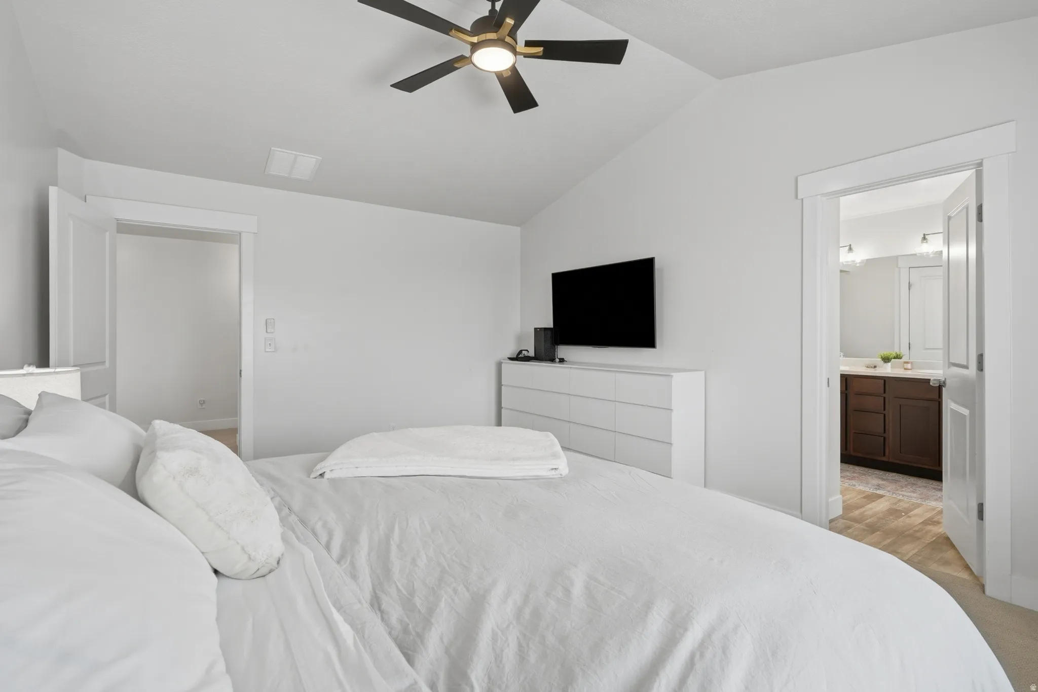 Bedroom featuring a vaulted ceiling and a ceiling fan with integrated lighting