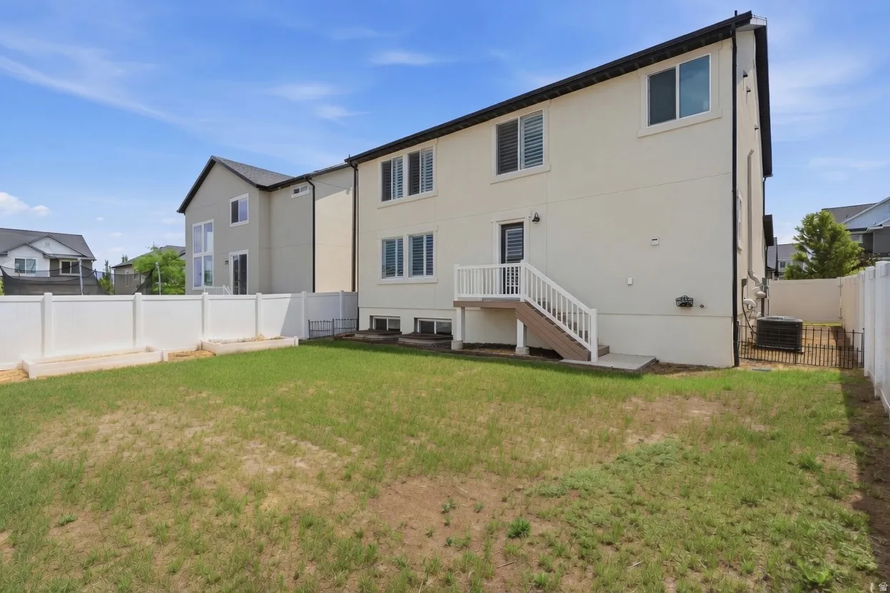 Rear exterior with a cream stucco finish and black trim