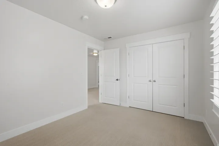 Neutral color palette with light beige carpeting and white walls