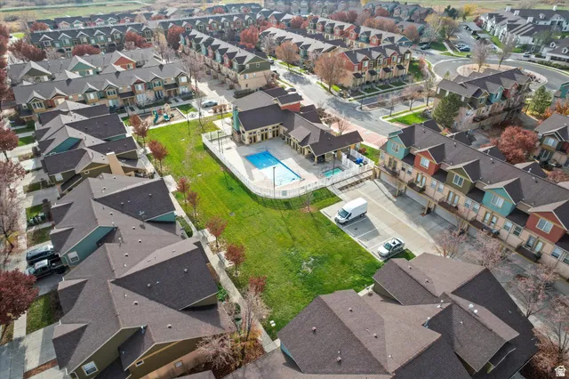 Aerial perspective of a residential community featuring townhomes with varied facade colors