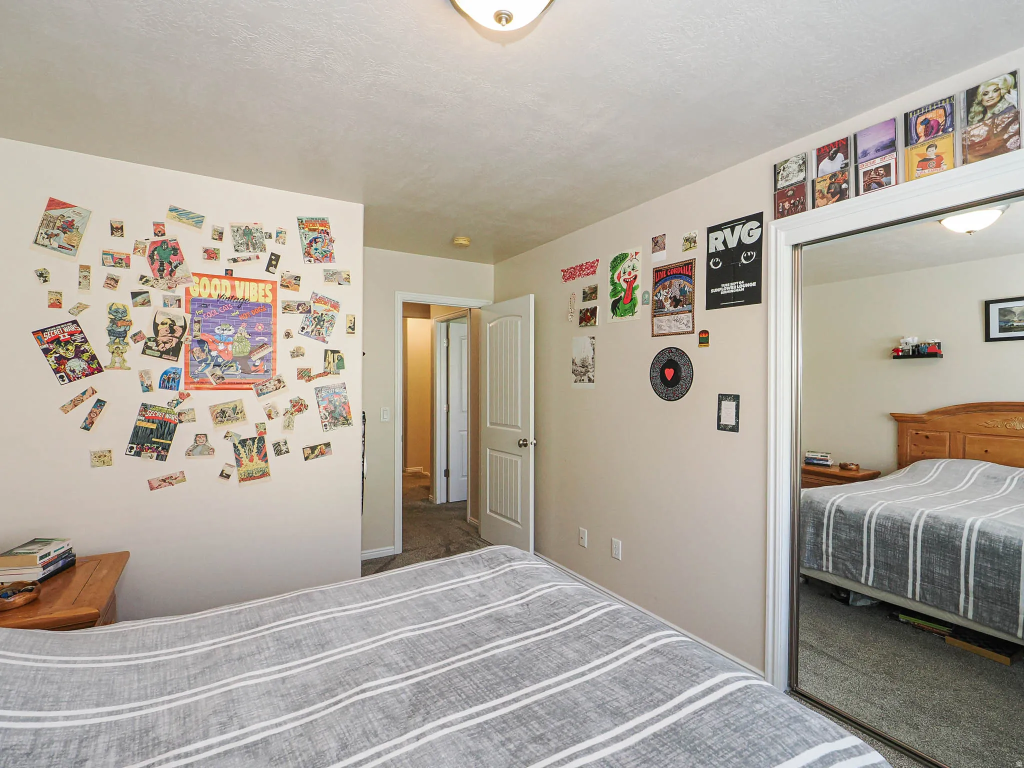Wall-to-wall carpeting and a ceiling-mounted light fixture define this room