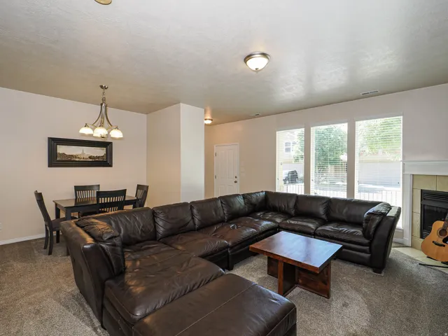 Open-concept living area featuring neutral-toned walls and carpet flooring