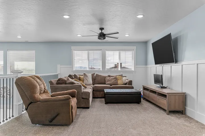 Carpeted bonus room with recessed lighting and a ceiling fan