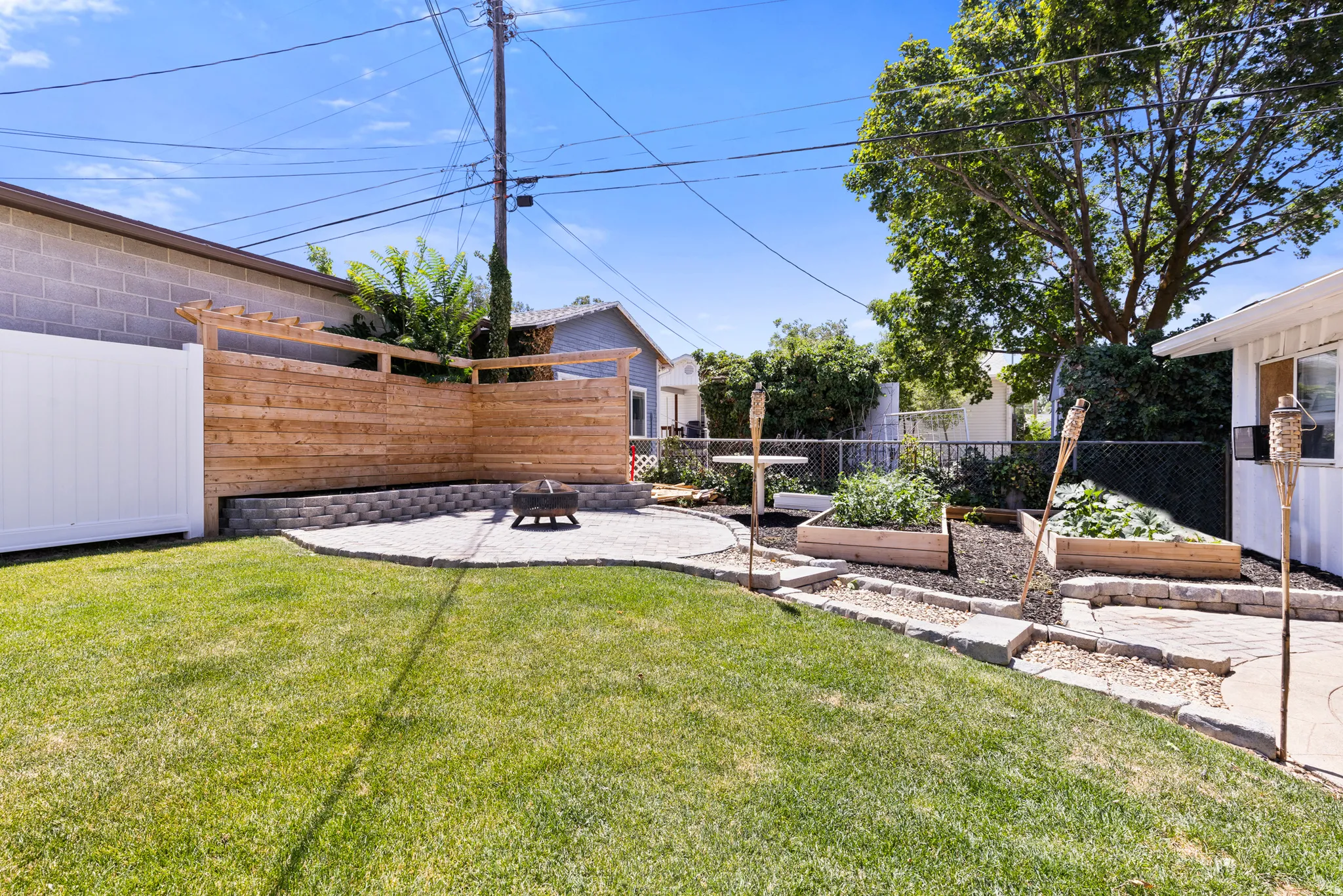 Expansive backyard featuring a lush lawn, a