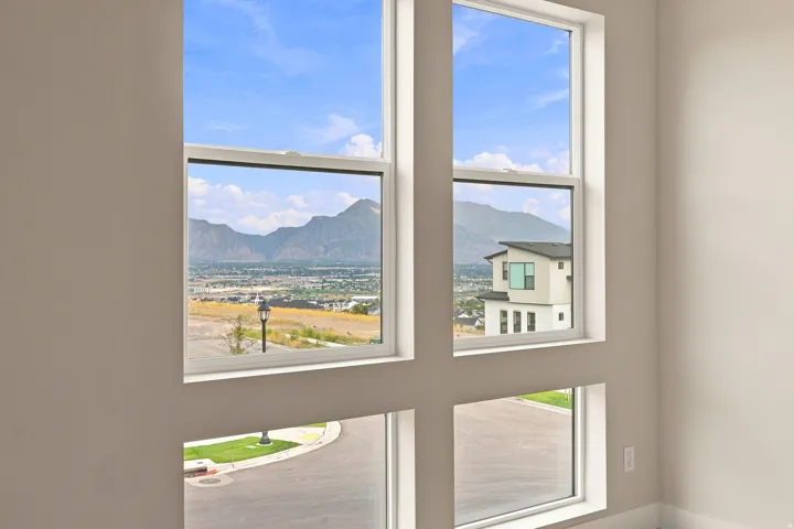 Expansive window array with white frames, offering multiple exposures to the surrounding scenery