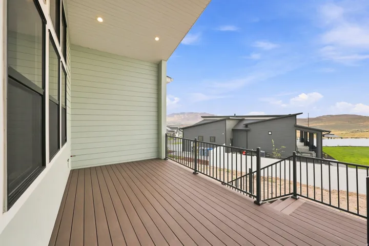 Expansive deck with composite decking and black metal railings