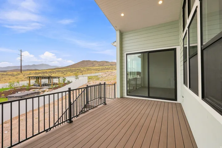 Covered outdoor deck with composite decking and black metal railings