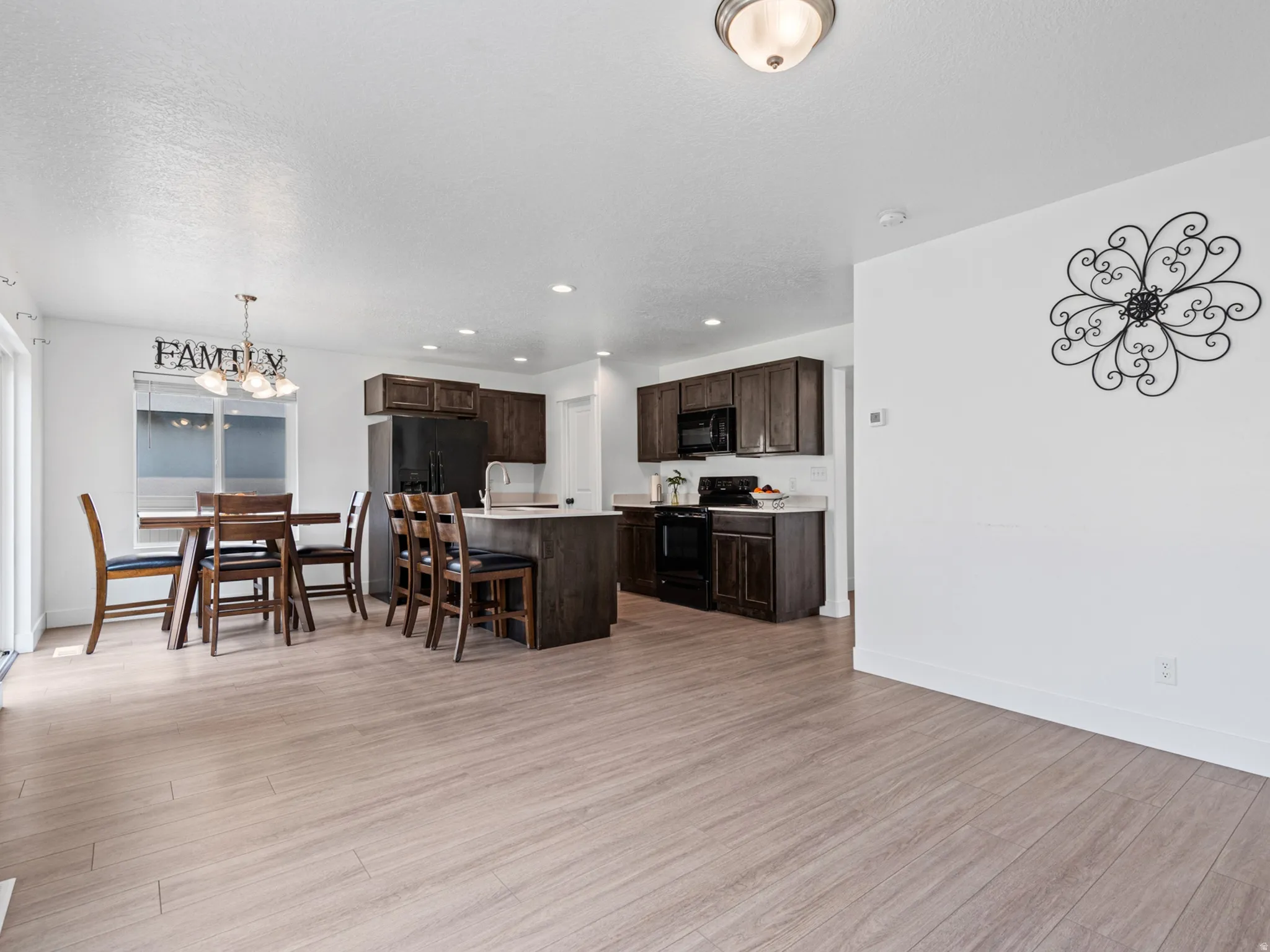 Open-concept living area featuring wood-finish flooring