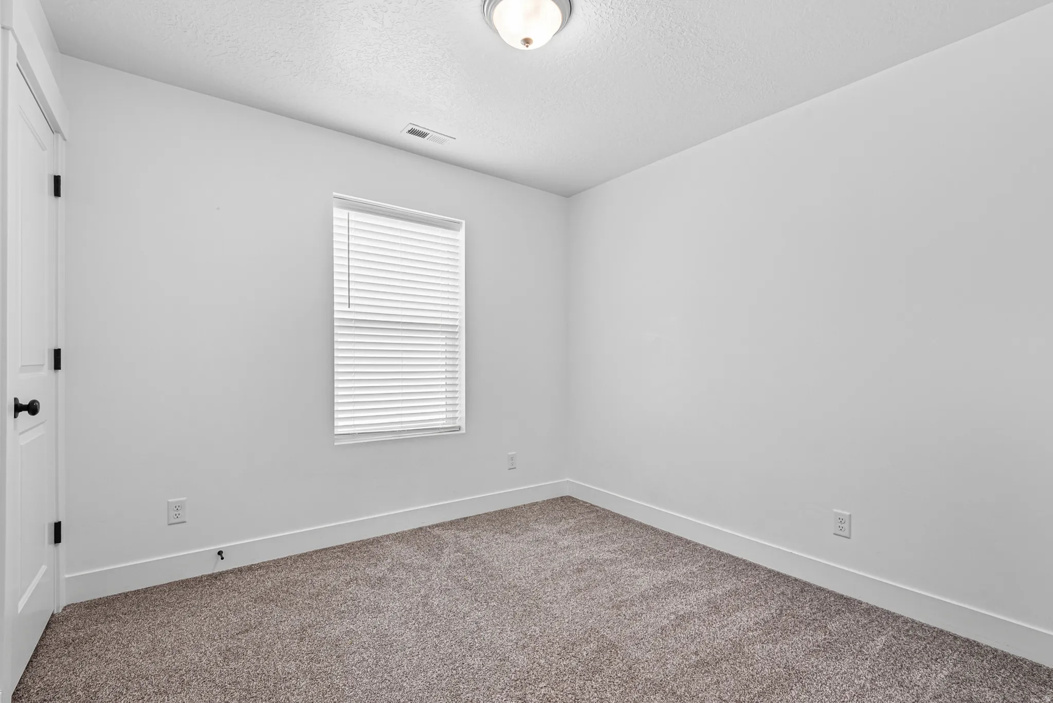 Neutral-toned carpeting paired with white walls and trim