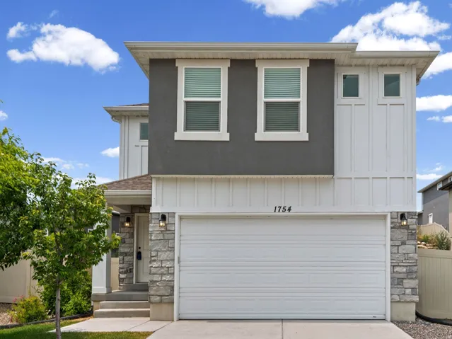 Contemporary-style residence featuring a two-story design with a prominent attached garage