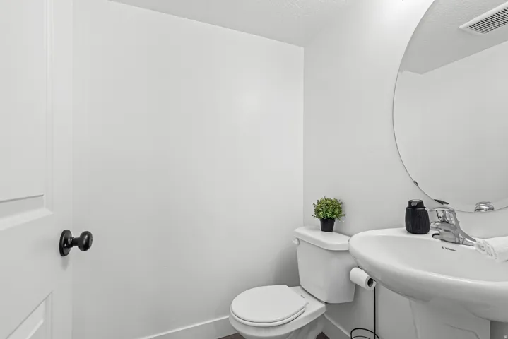 White pedestal sink with chrome faucet