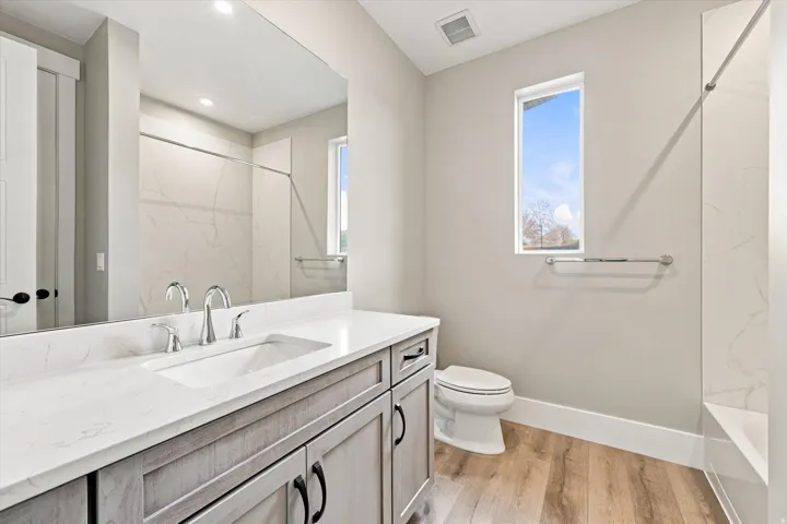 Integrated vanity with an undermount sink and polished chrome faucet