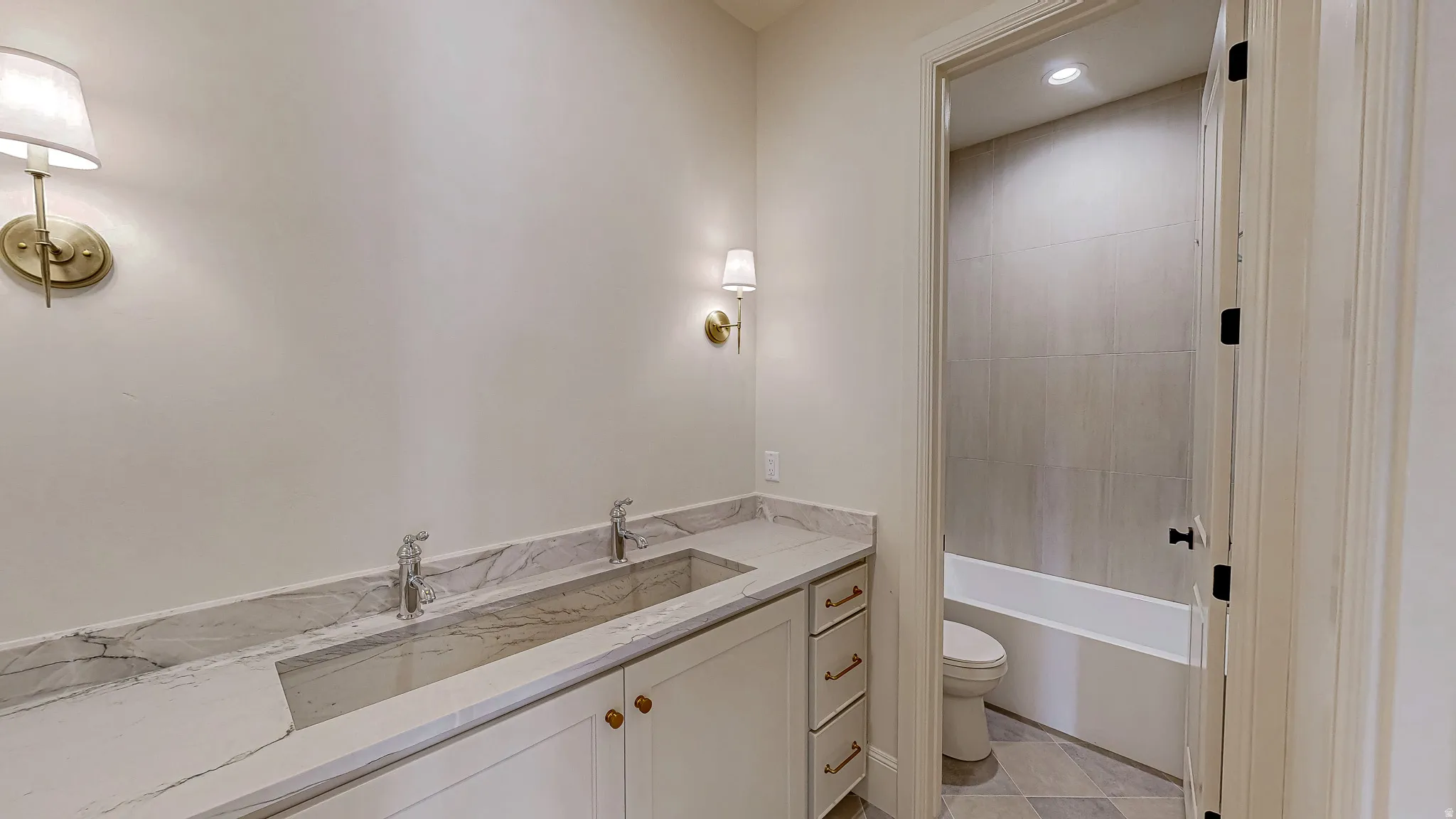 Dual vanity with stone countertop and integrated trough sink