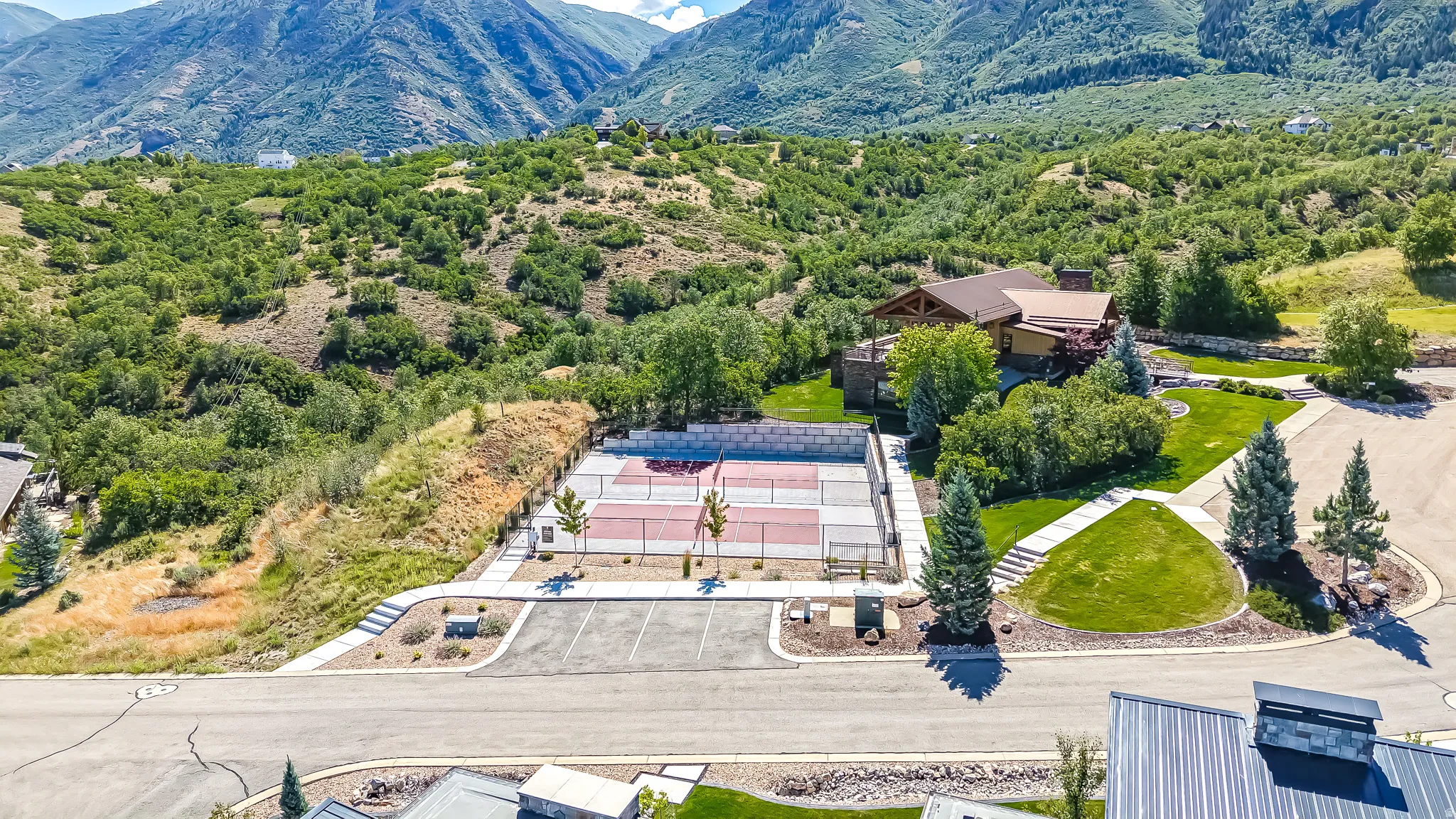 Professional-grade tennis and pickleball courts with paved surrounds
