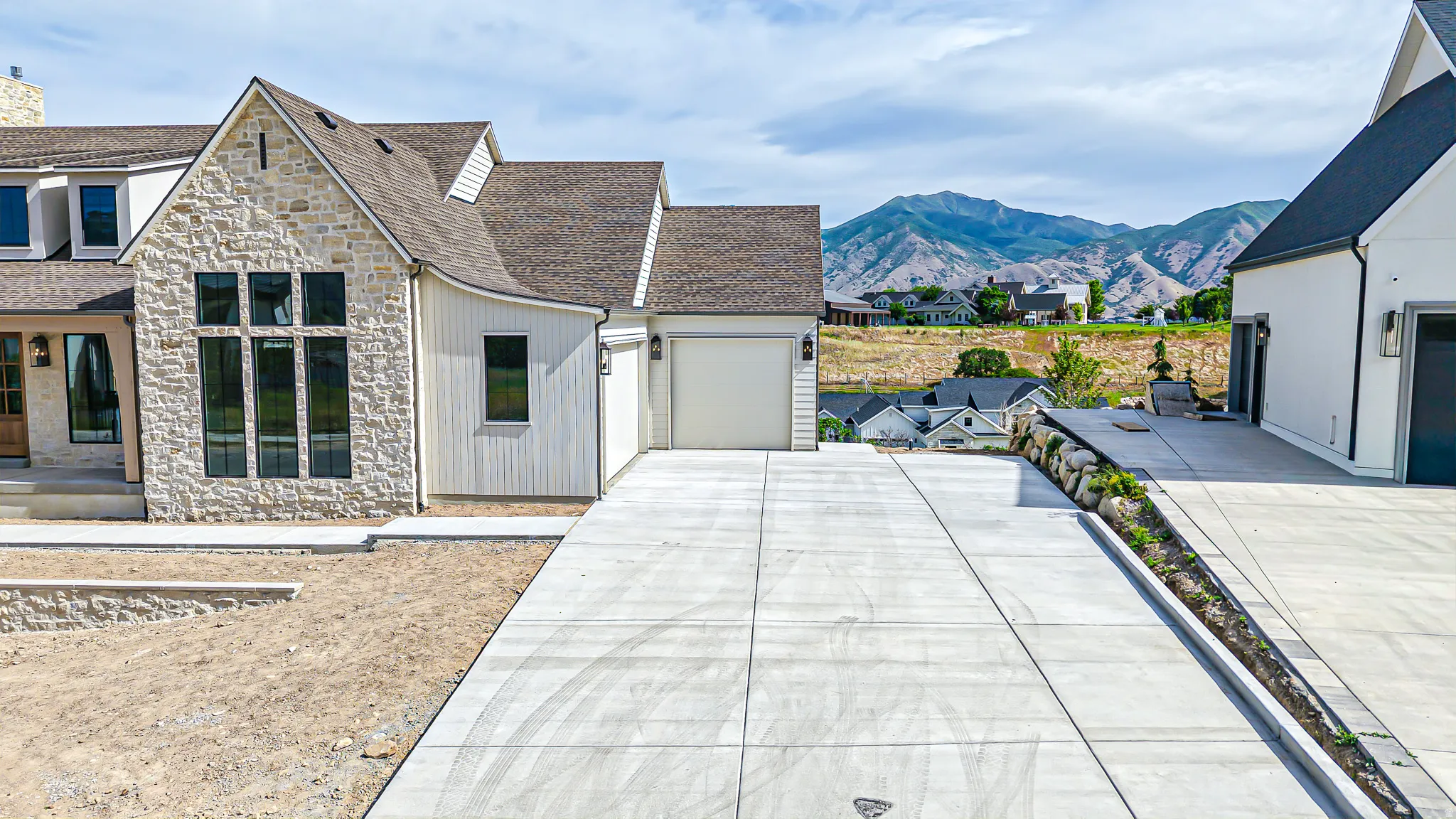 Stone and vertical siding facade with large multi-pane windows