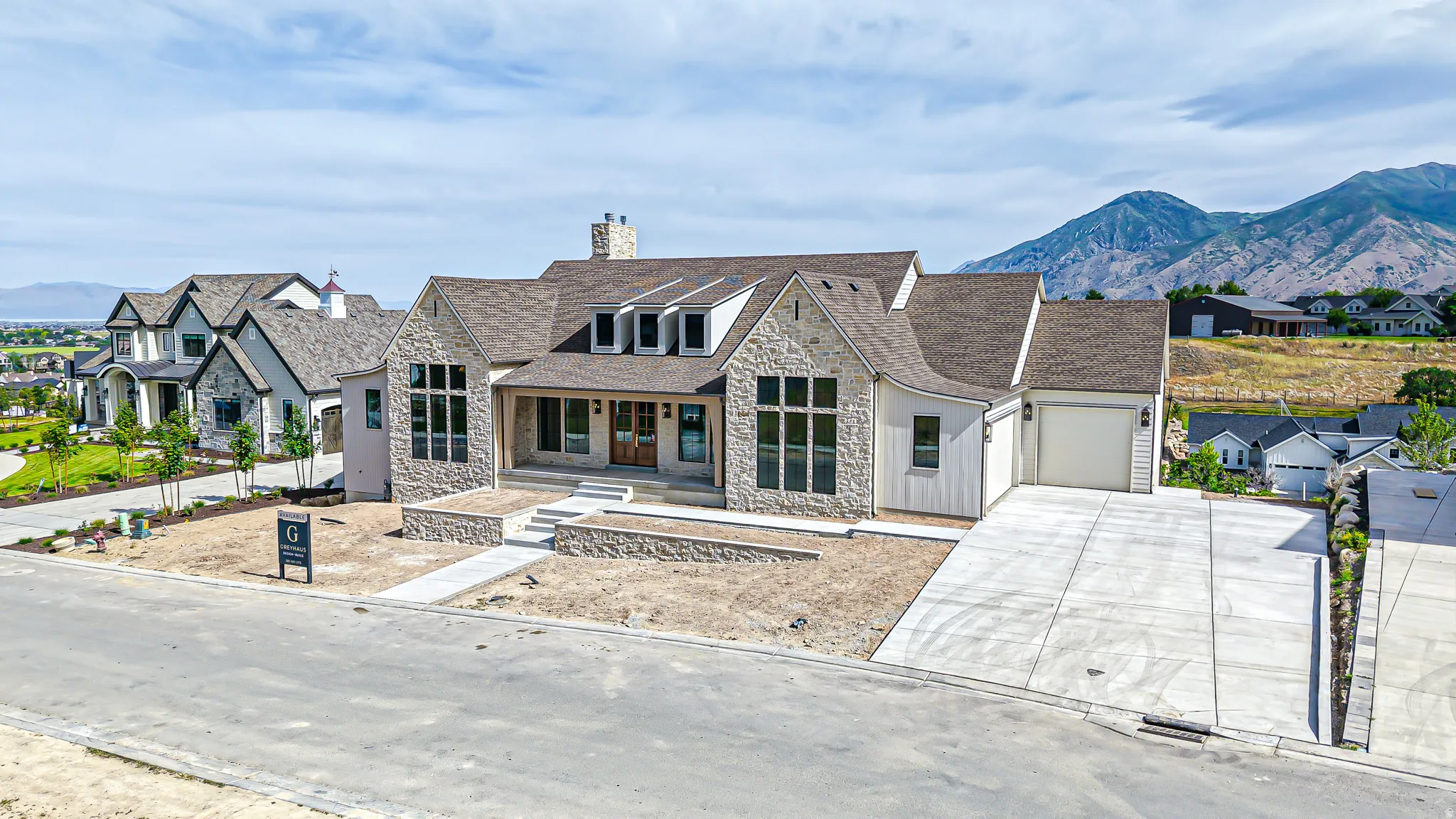 Stone and vertical siding exterior with a multi-gabled roofline