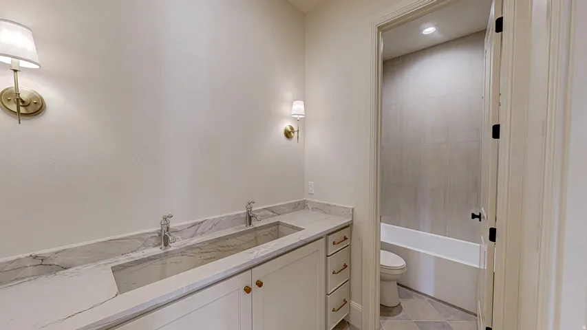 Dual vanity with stone countertop and integrated trough sink