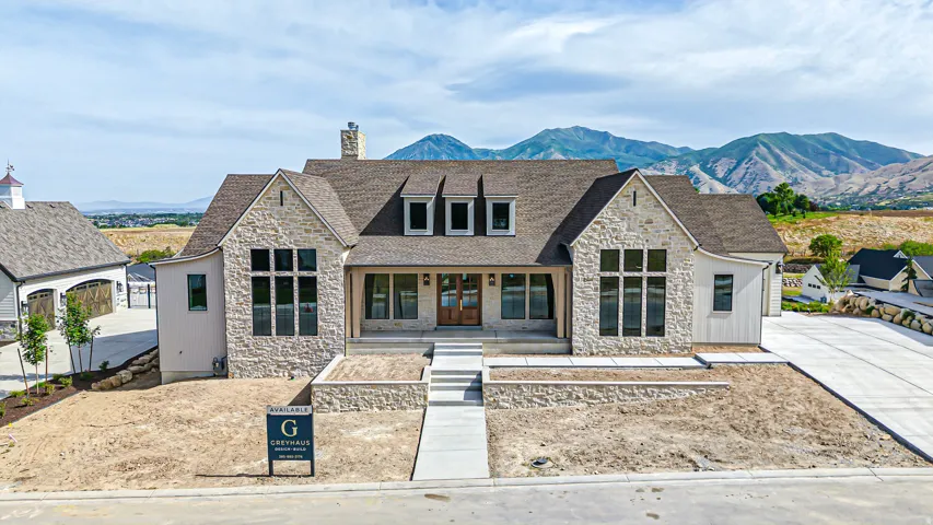 Stone and siding exterior with a prominent front entrance featuring double wood doors