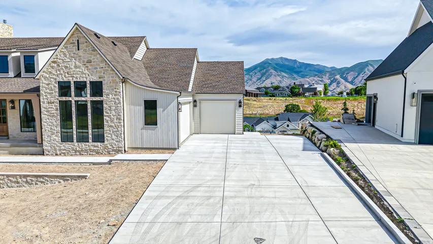 Stone and vertical siding facade with large multi-pane windows