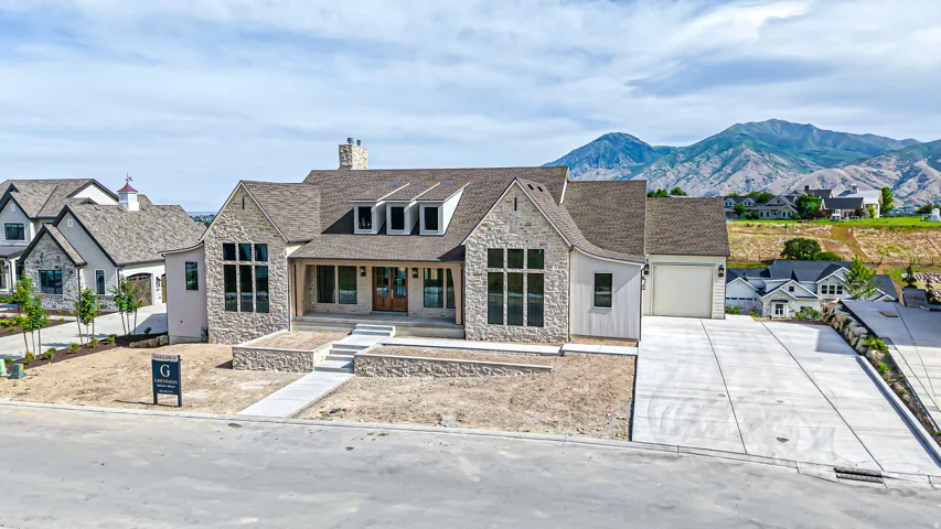 Stone and siding exterior with a prominent front entrance featuring a covered porch