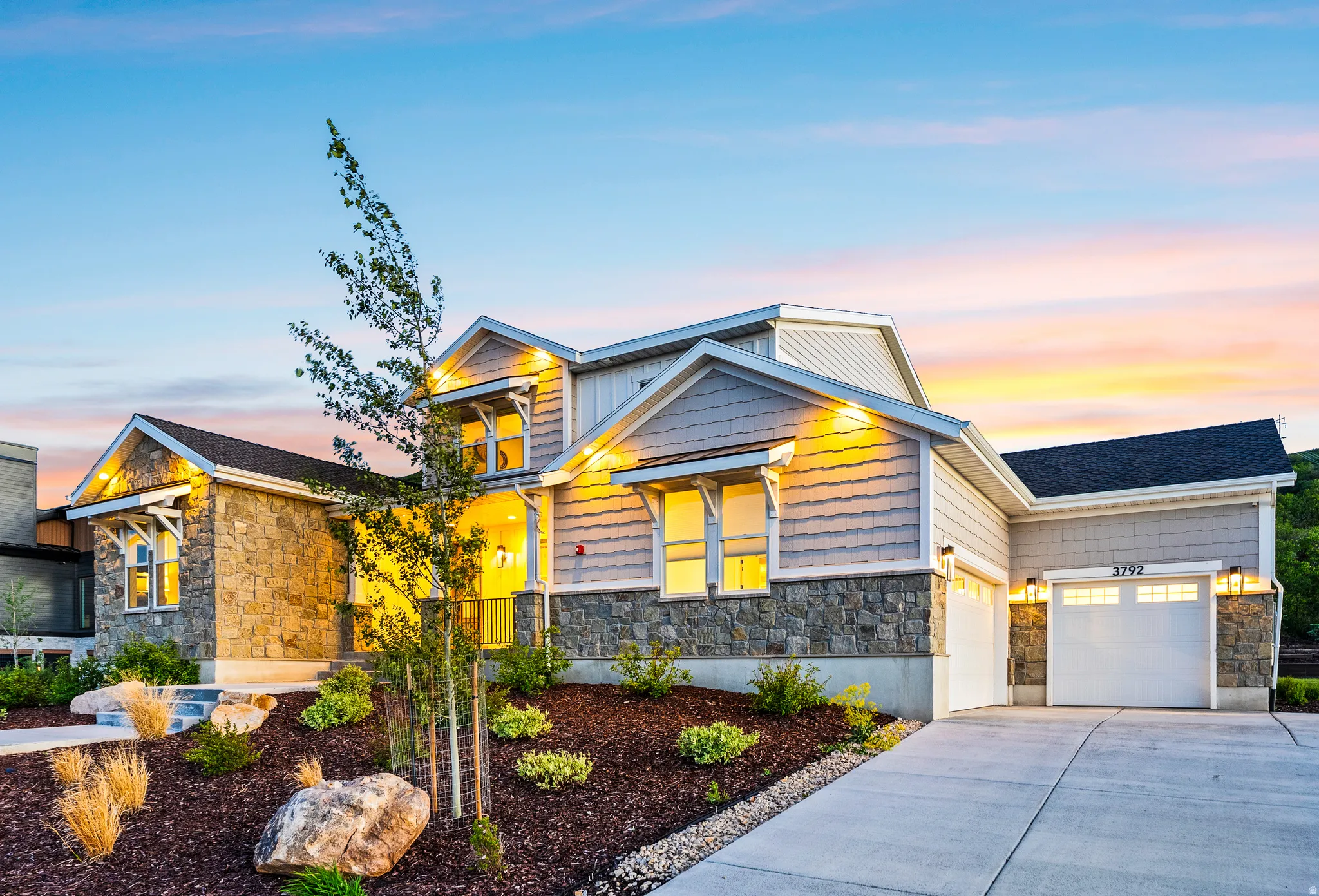 Contemporary home exterior featuring stone and horizontal siding