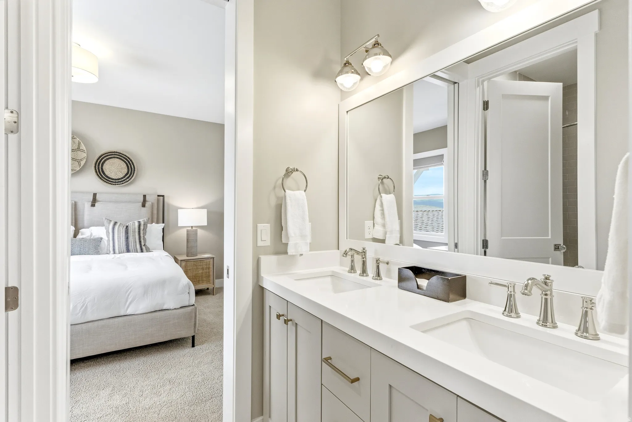 Double vanity with light gray cabinetry, brushed nickel hardware, and dual undermount sinks