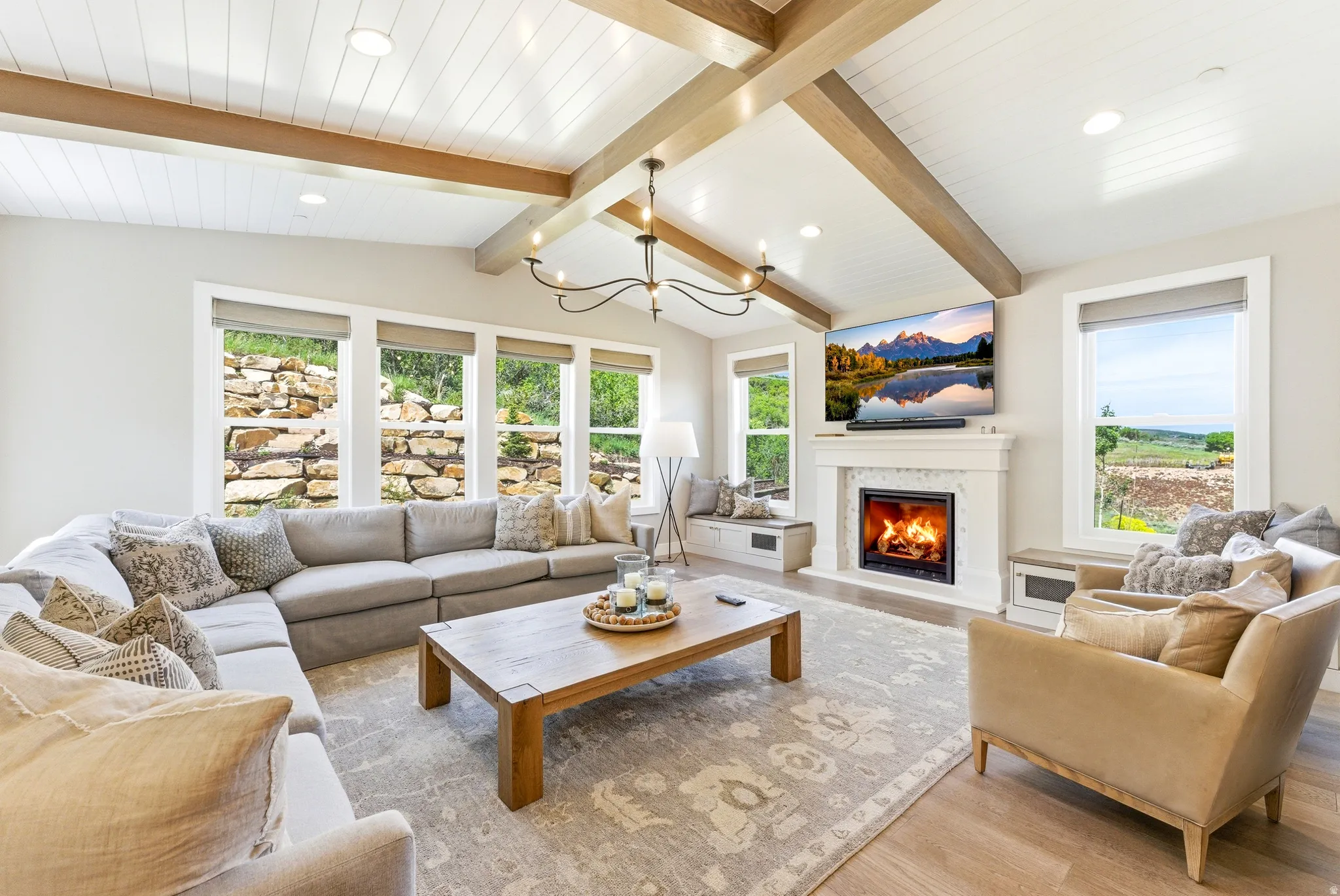 Vaulted ceiling with exposed wood beams and white shiplap finish