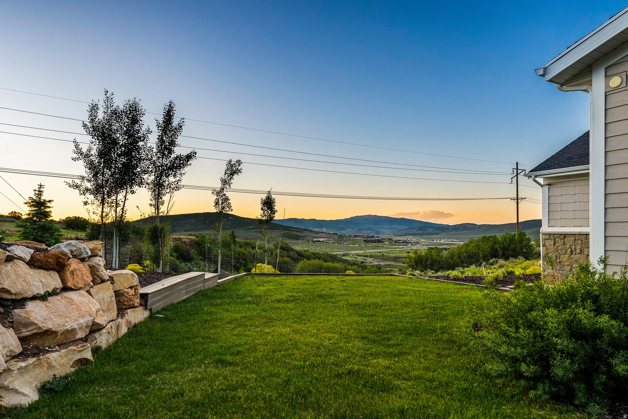 Expansive green lawn with mountain backdrop