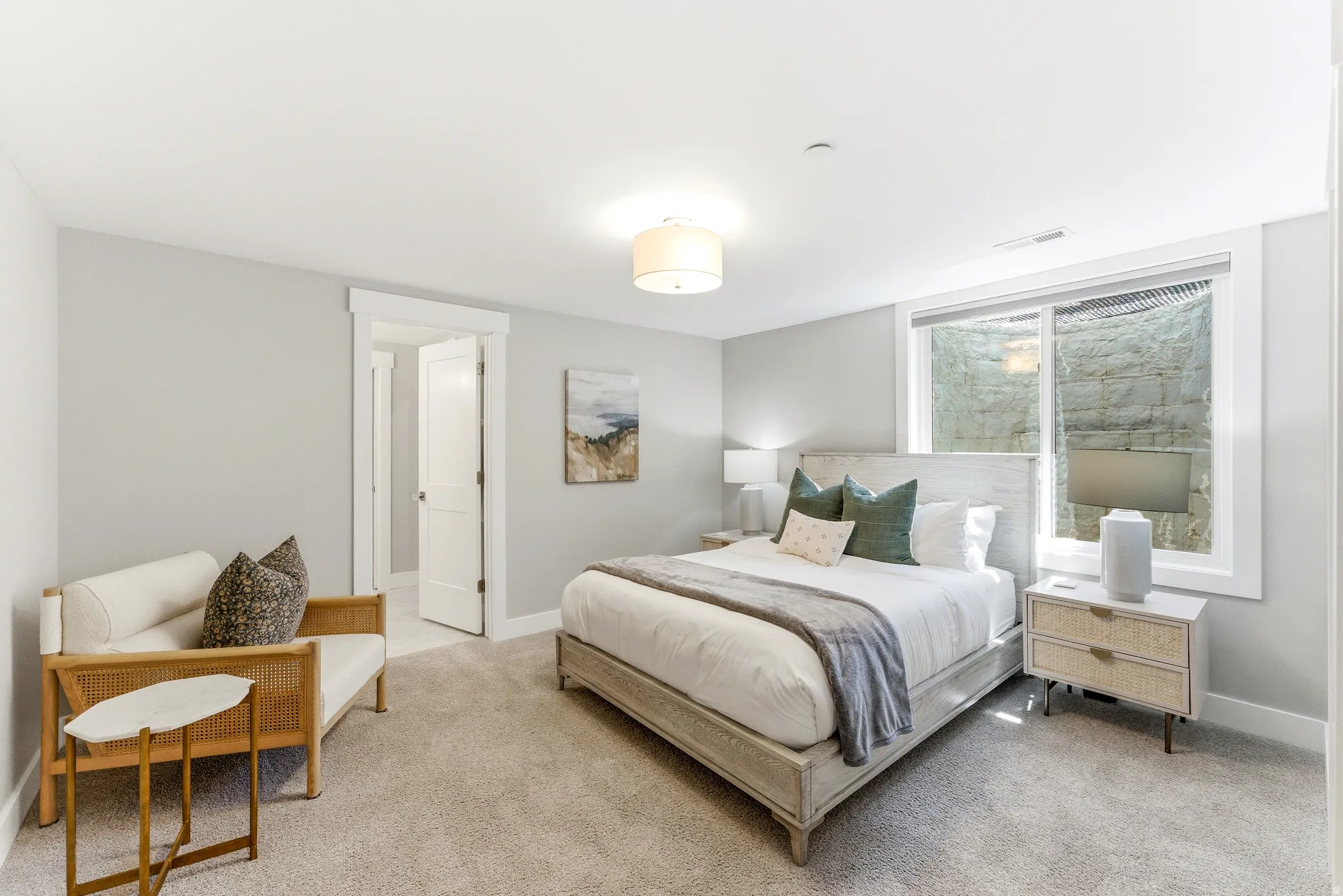 Carpeted room with a ceiling-mounted drum light fixture and light gray wall paint