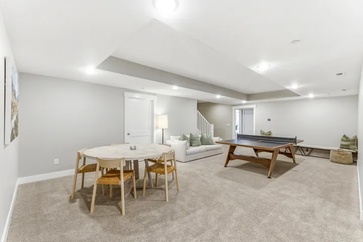 Finished basement featuring recessed lighting and neutral-toned carpeting