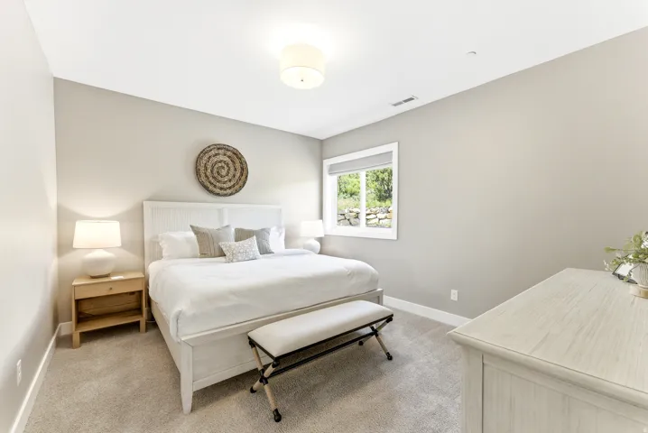 Carpeted room with a window featuring a roller shade, recessed lighting, and a drum ceiling light fixture