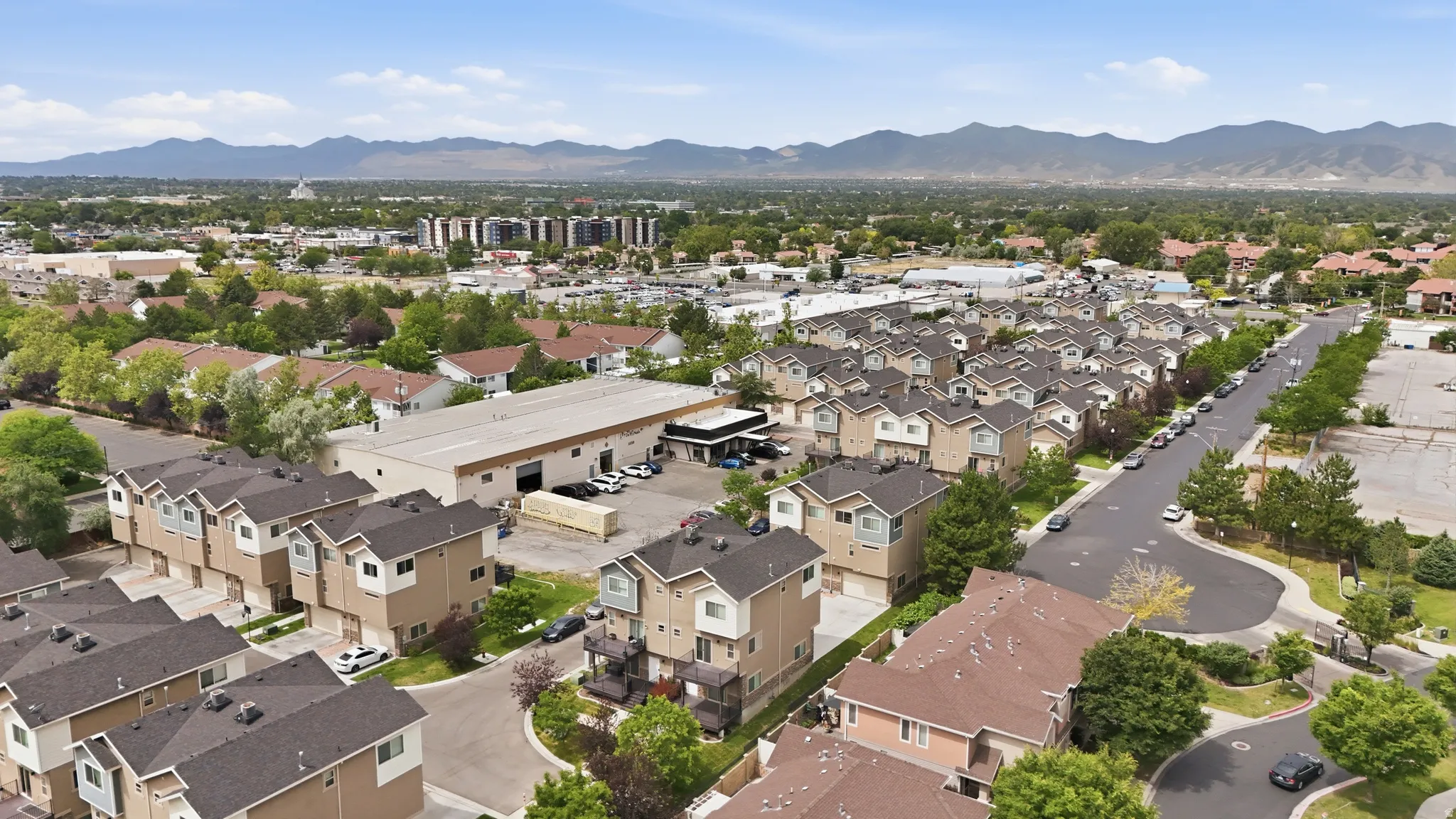 Expansive aerial perspective showcasing a residential community with multiple townhome-style properties