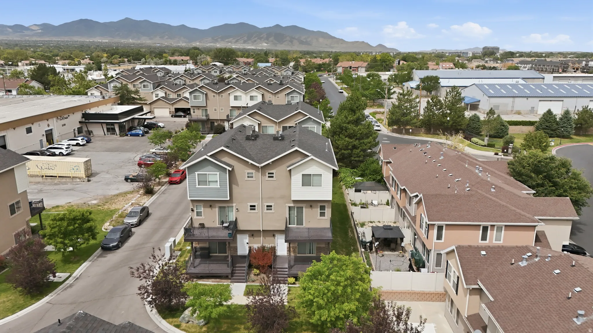 Modern townhome community featuring multi-level residences with contrasting siding and dark-pitched roofs