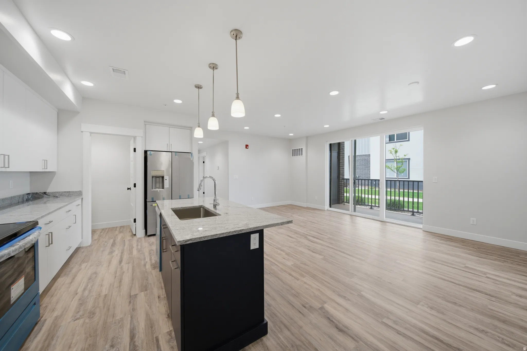 Spacious open-concept kitchen and living area featuring wood-finish flooring