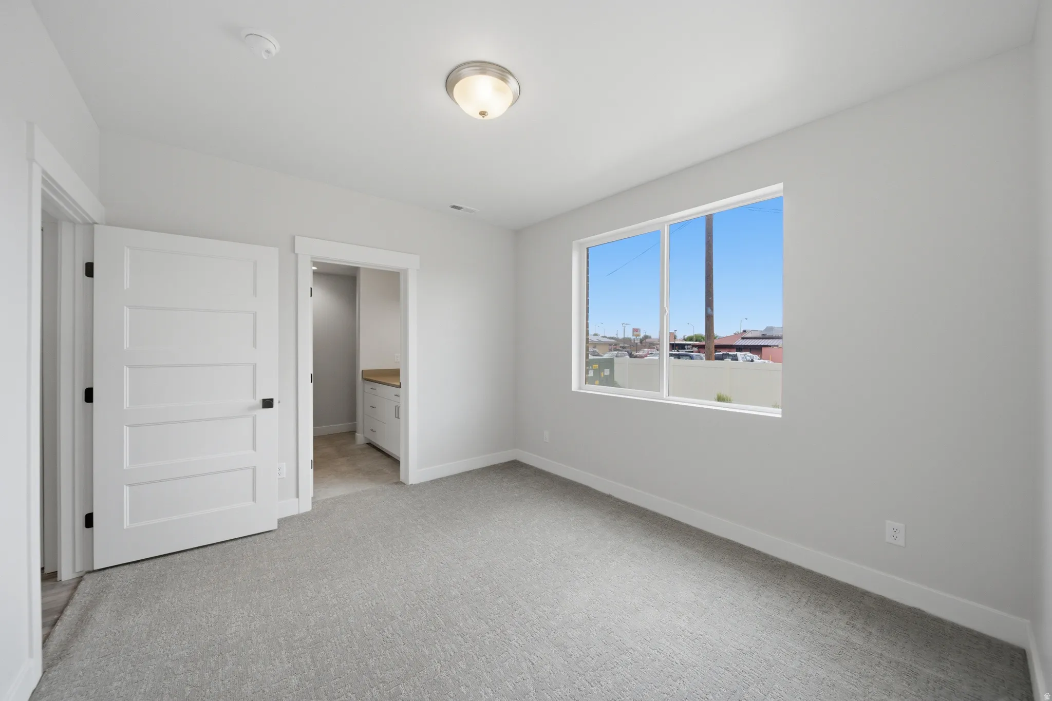 Neutral gray wall paint complementing gray carpet flooring