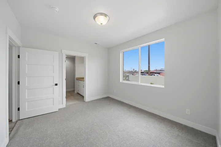 Neutral gray wall paint complementing gray carpet flooring