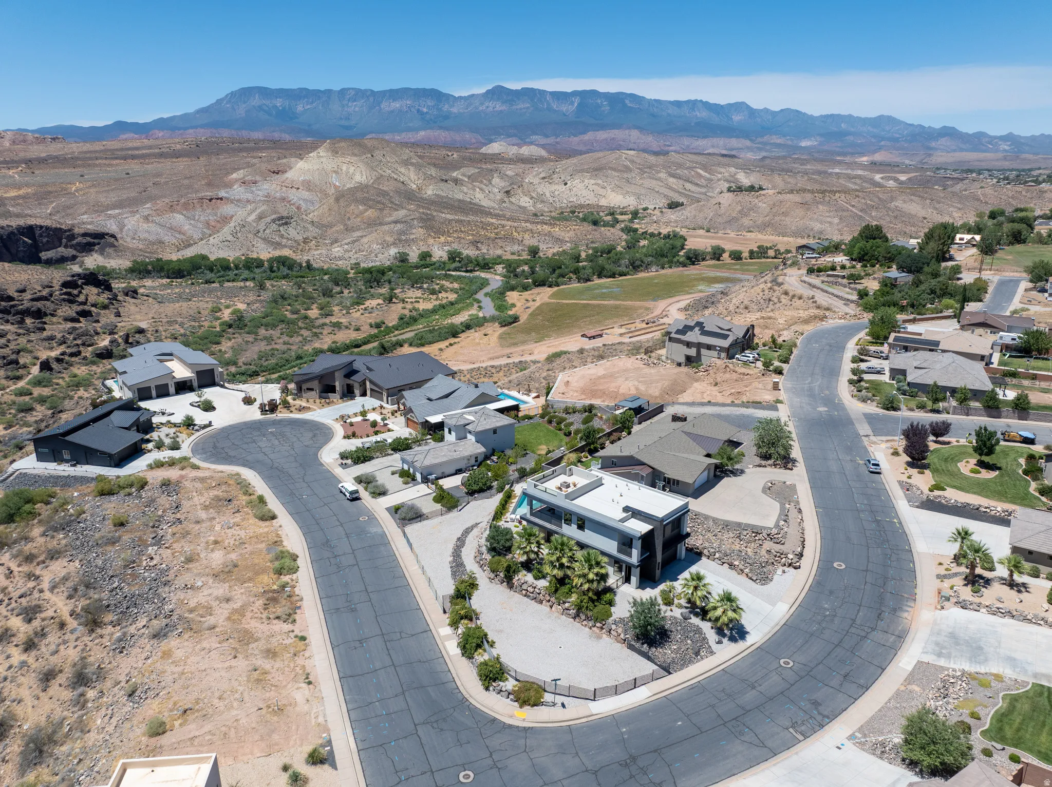 Elevated cul-de-sac properties featuring contemporary and traditional architecture, with mountain and desert landscape scenery