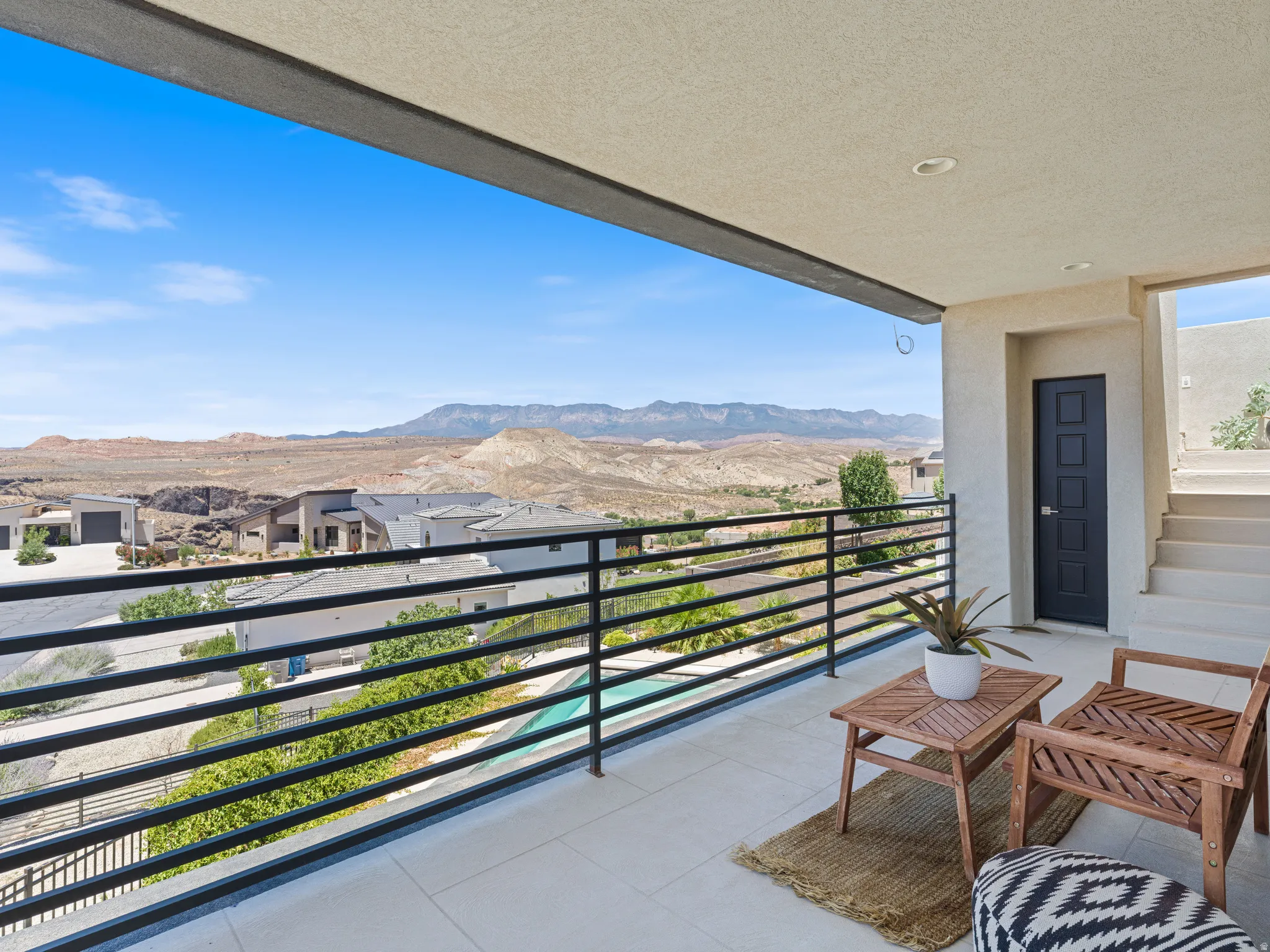 Spacious outdoor balcony outside the master suite and additional storage closet and stairs to the roof top deck