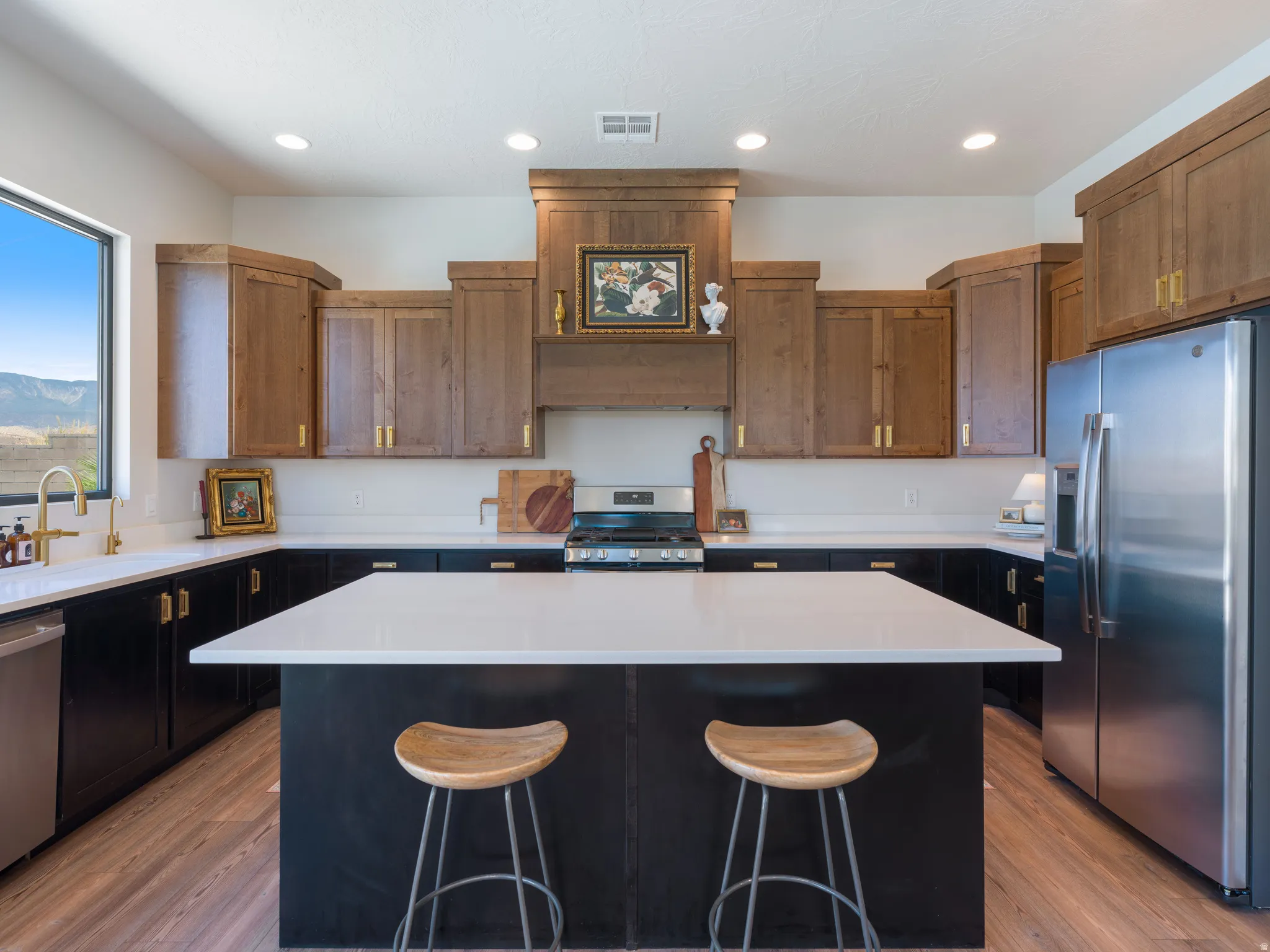 Modern kitchen with a large center island featuring a pristine white countertop