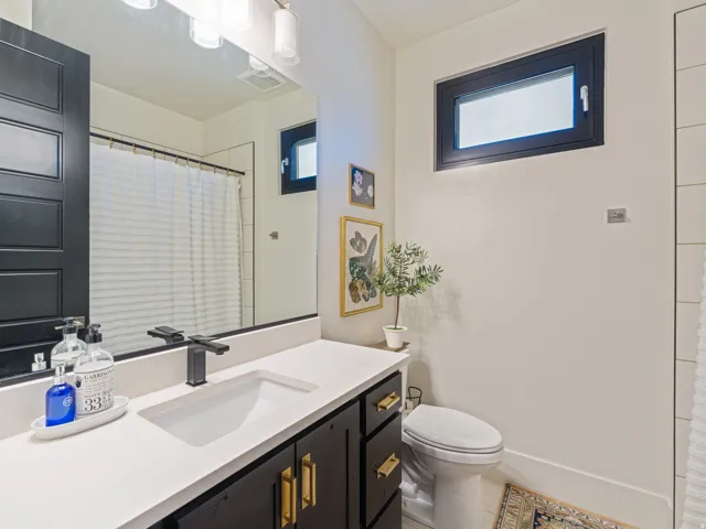 Vanity with integrated sink, matte black faucet, and white countertop