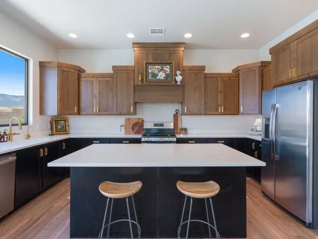 Modern kitchen with a large center island featuring a pristine white countertop