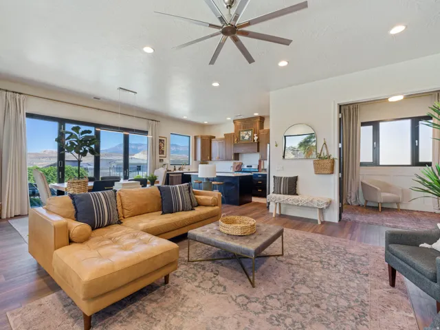 Open-concept living space with LVP, recessed lighting, and a modern ceiling fan
