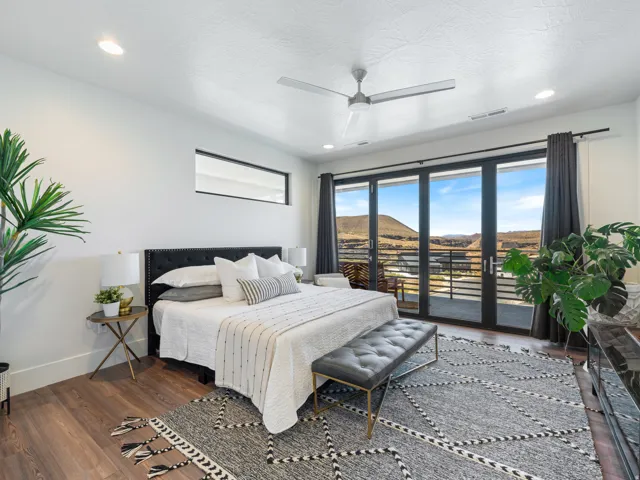 Spacious room featuring a wall of windows that open completely and a contemporary ceiling fan