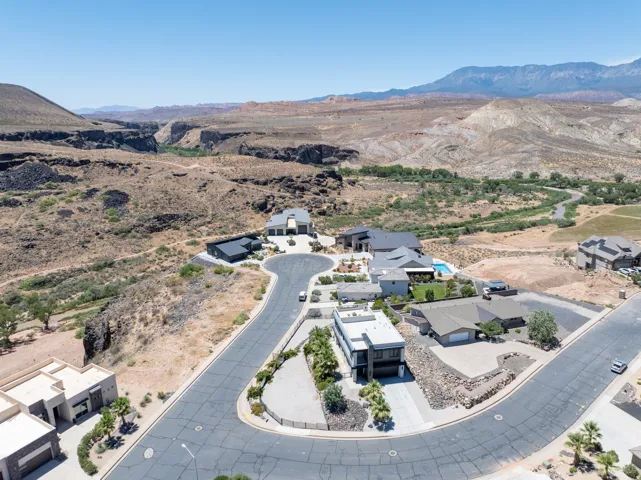 Aerial perspective showcasing a residential development with custom homes and a desert landscape
