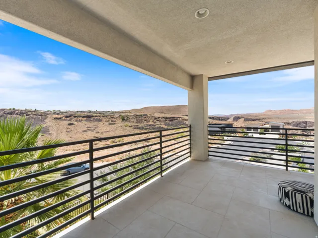 Covered outdoor terrace featuring a desert landscape backdrop