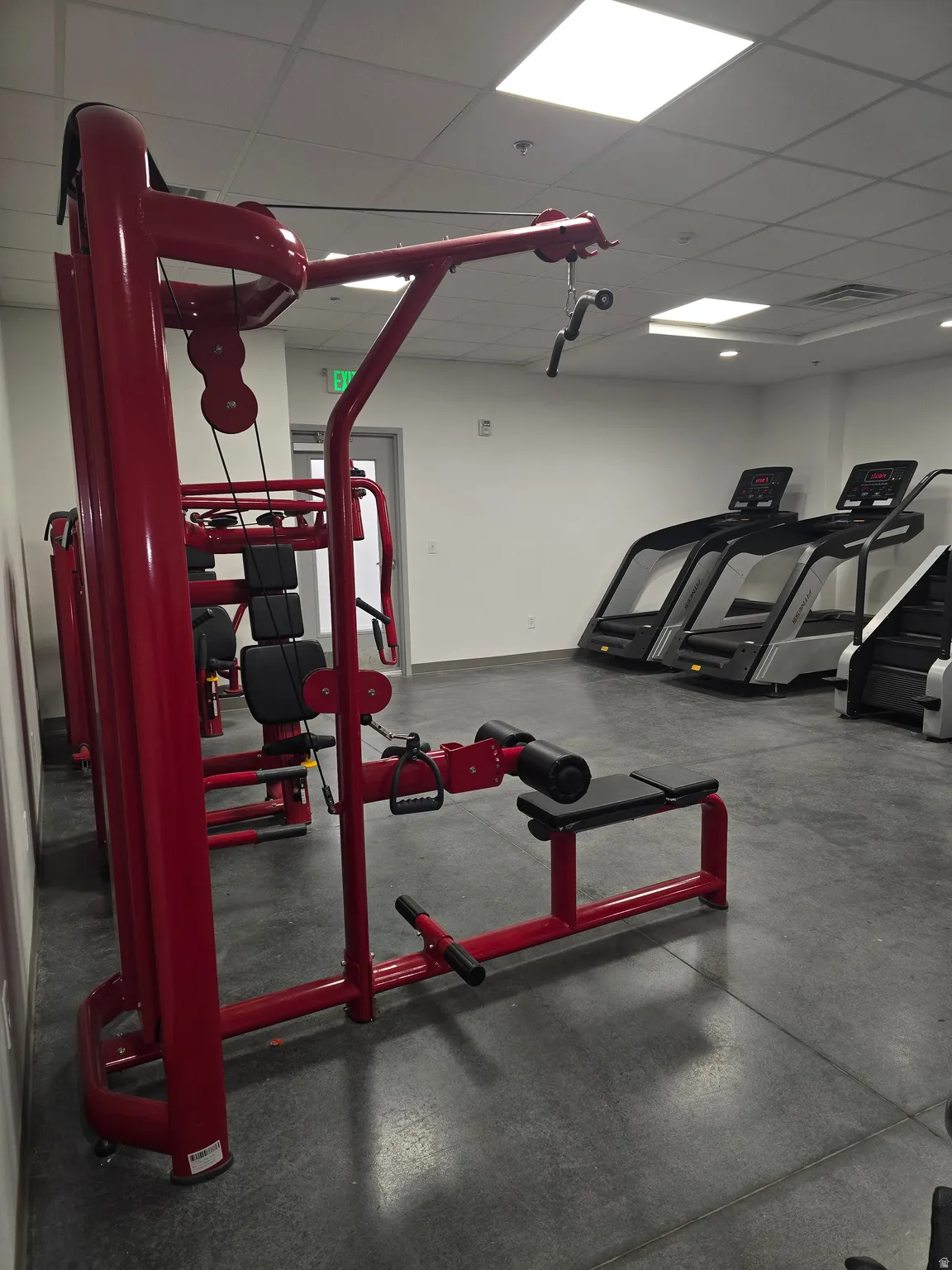 Fitness center featuring durable flooring, recessed lighting, and white walls