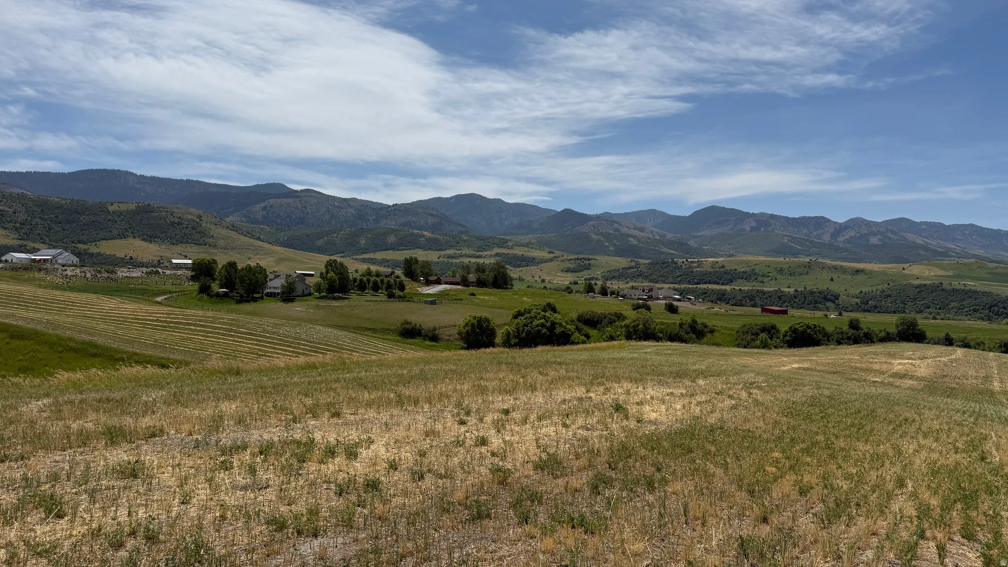 Expansive property featuring rolling hills and distant mountain ranges