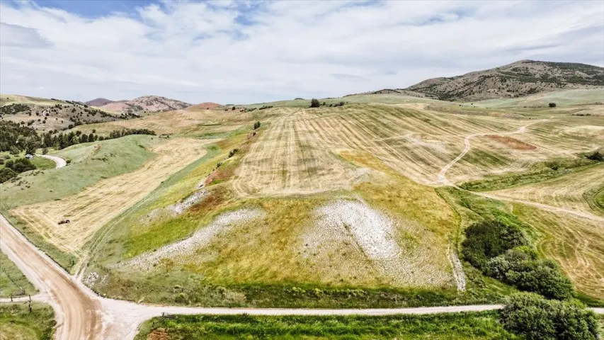 Expansive open land featuring rolling hills and cultivated fields